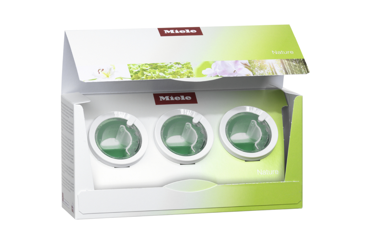 Miele-Verpackung mit drei grünen Flüssigkeitsbehältern und Naturmotiven.