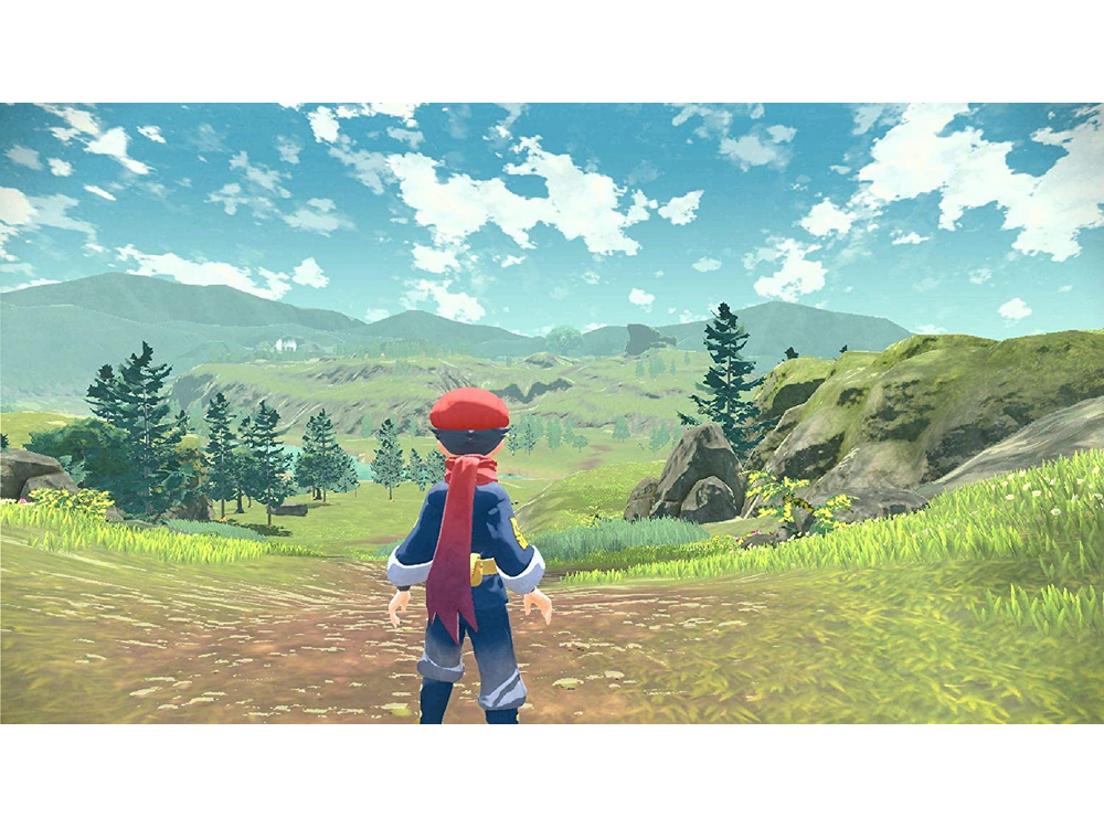 Una persona en un campo, con un sombrero rojo, mirando el paisaje verde.
