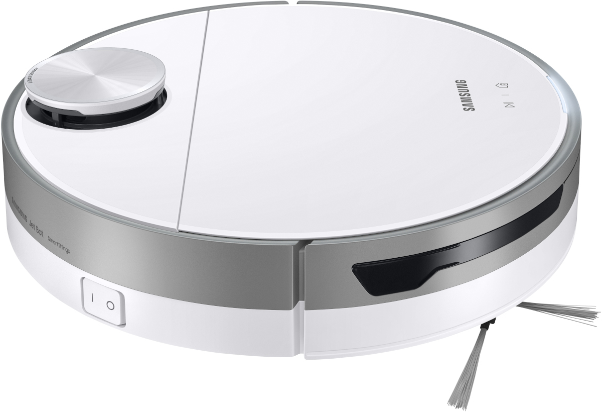 Aspirateur robot blanc et argenté. Il a un design circulaire, avec un bouton et un capteur.
