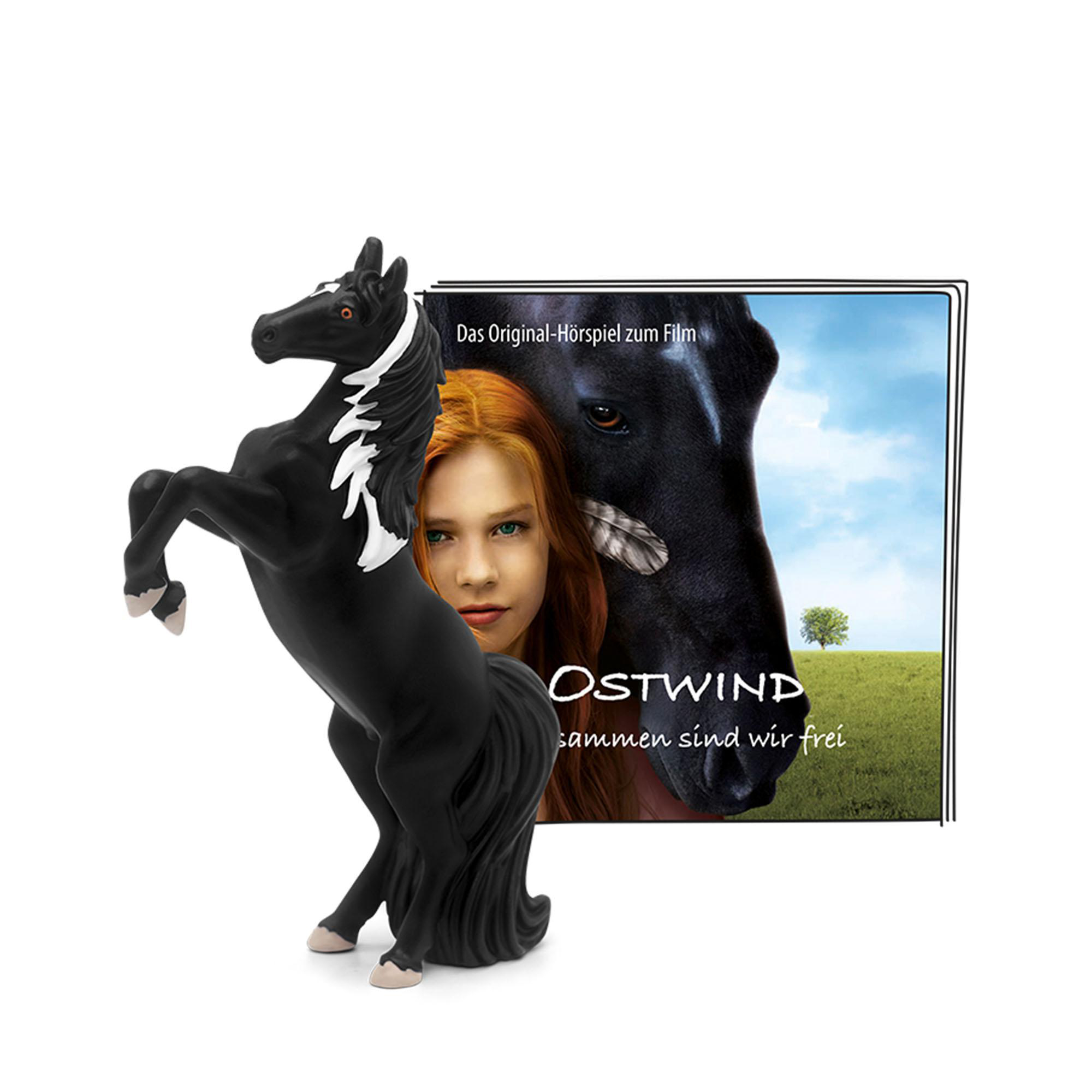 Spielzeugpferd, das sich aufbäumt. Ein Filmplakat mit Pferd und Mädchen rechts.