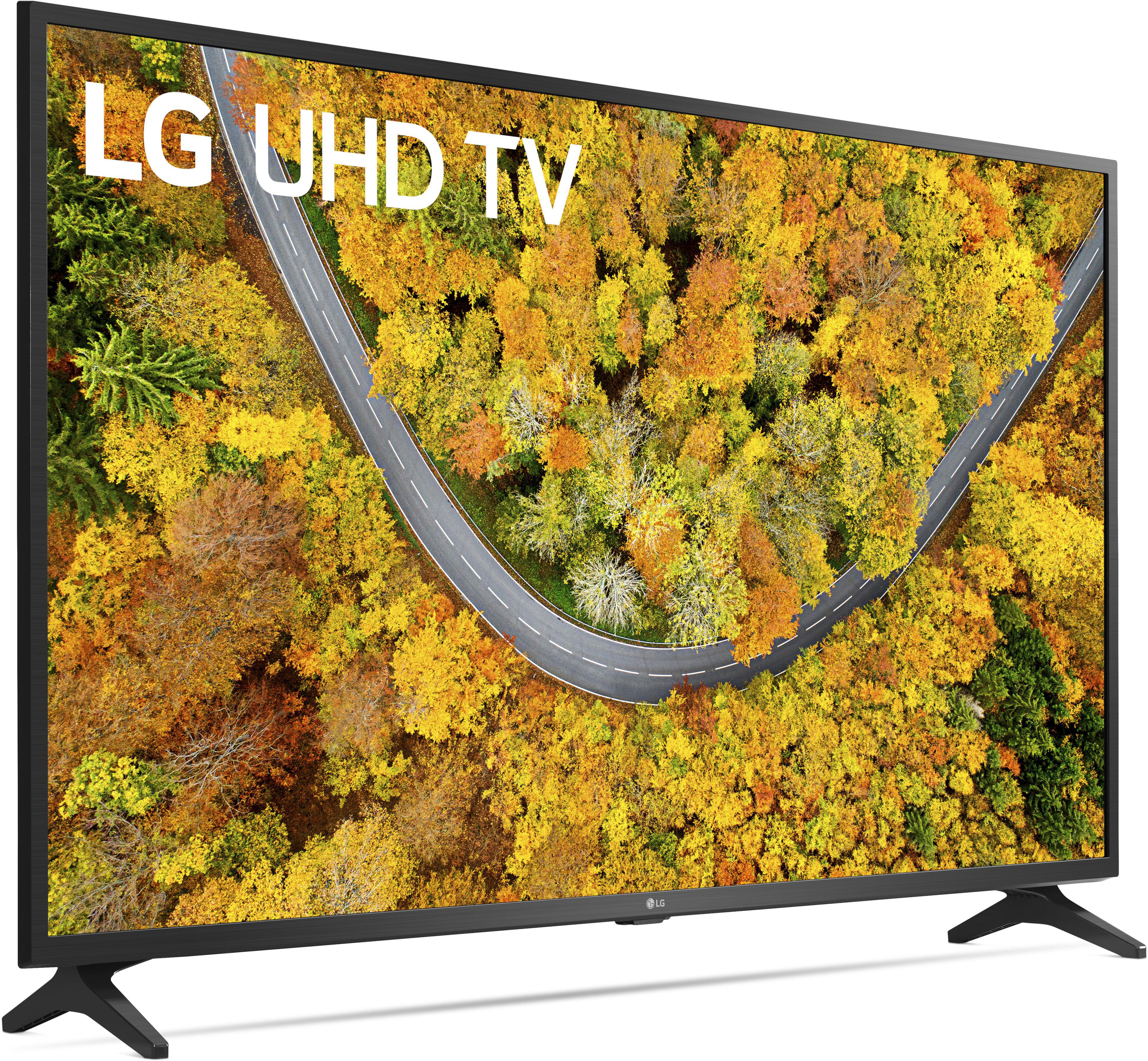 Ein LG UHD TV, der eine Straße durch einen Wald mit Herbstfarben zeigt.