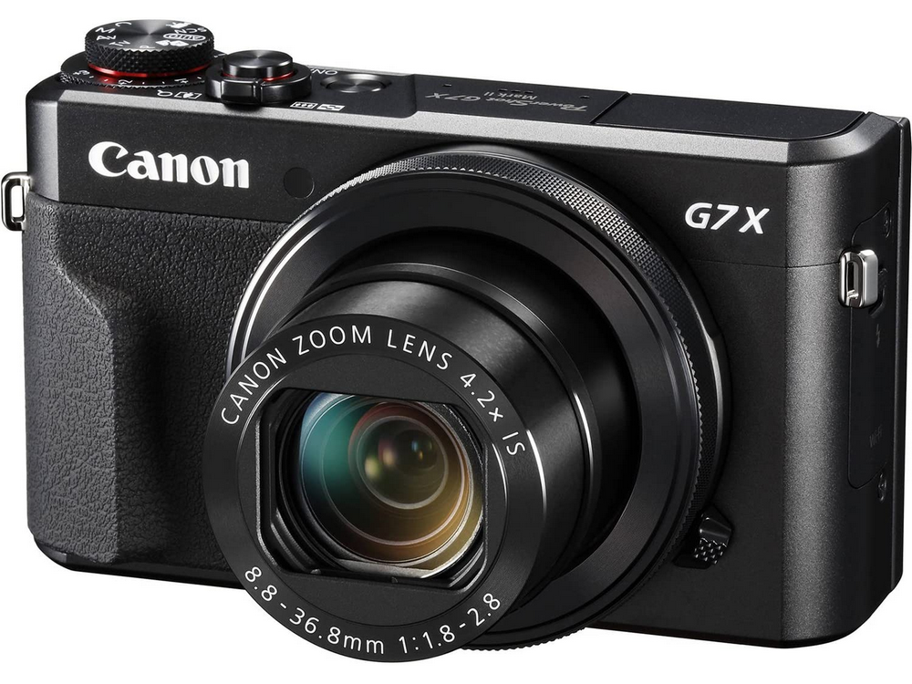 Cámara Canon G7X Mark II negra con lente y botones. Las marcas Canon y G7X son visibles.