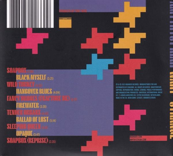 Album borító színes absztrakt formákkal és fehér szövegű dalfeliratokkal, sötét háttéren.