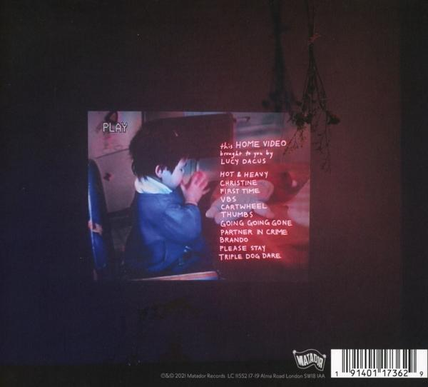 Albumcover mit einem Kind, das ein Video ansieht. Text enthält "this HOME VIDEO" und Songtitel.