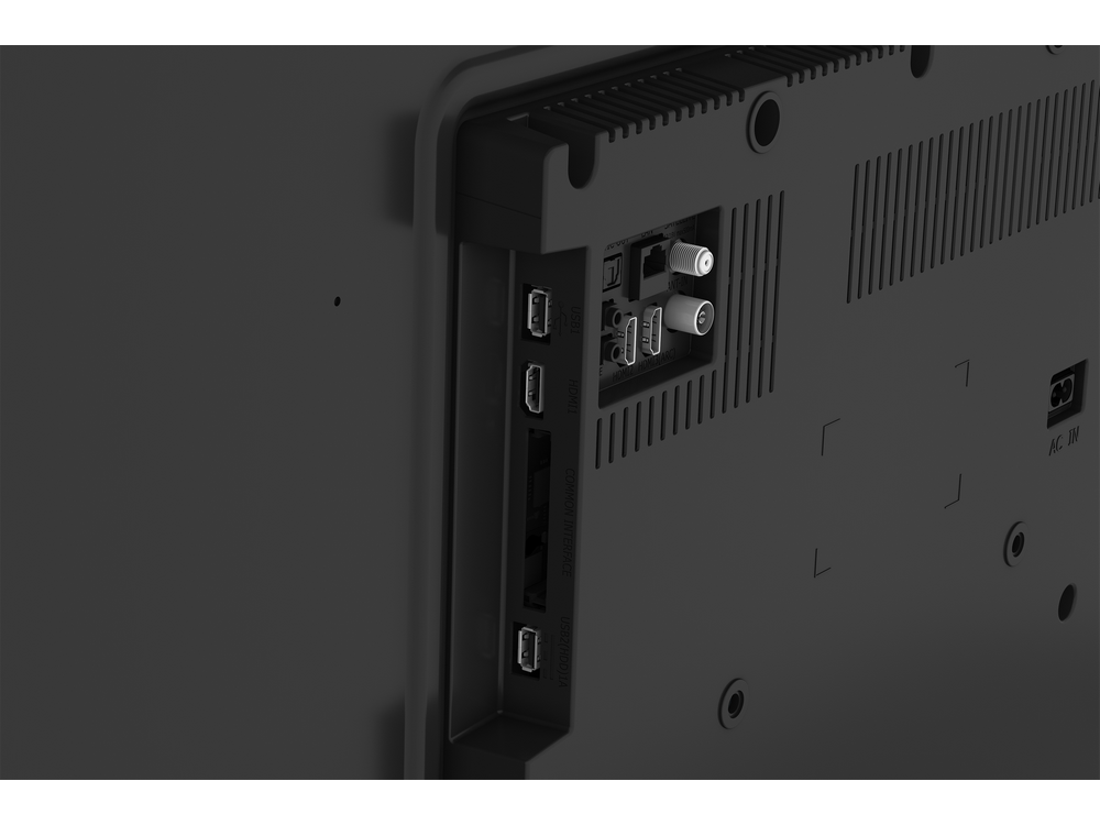 Primer plano de la parte trasera de un televisor negro con varios puertos y conectores. Puertos HDMI, USB y antena son visibles.