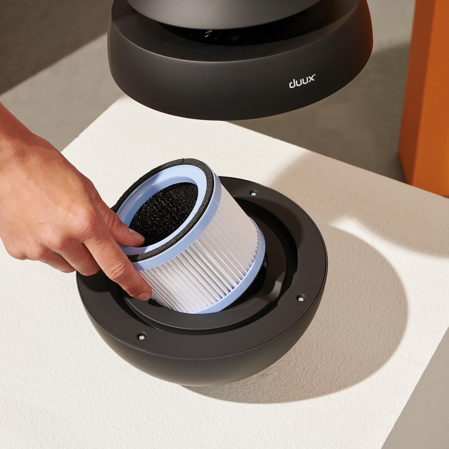 Air purifier filter being removed.