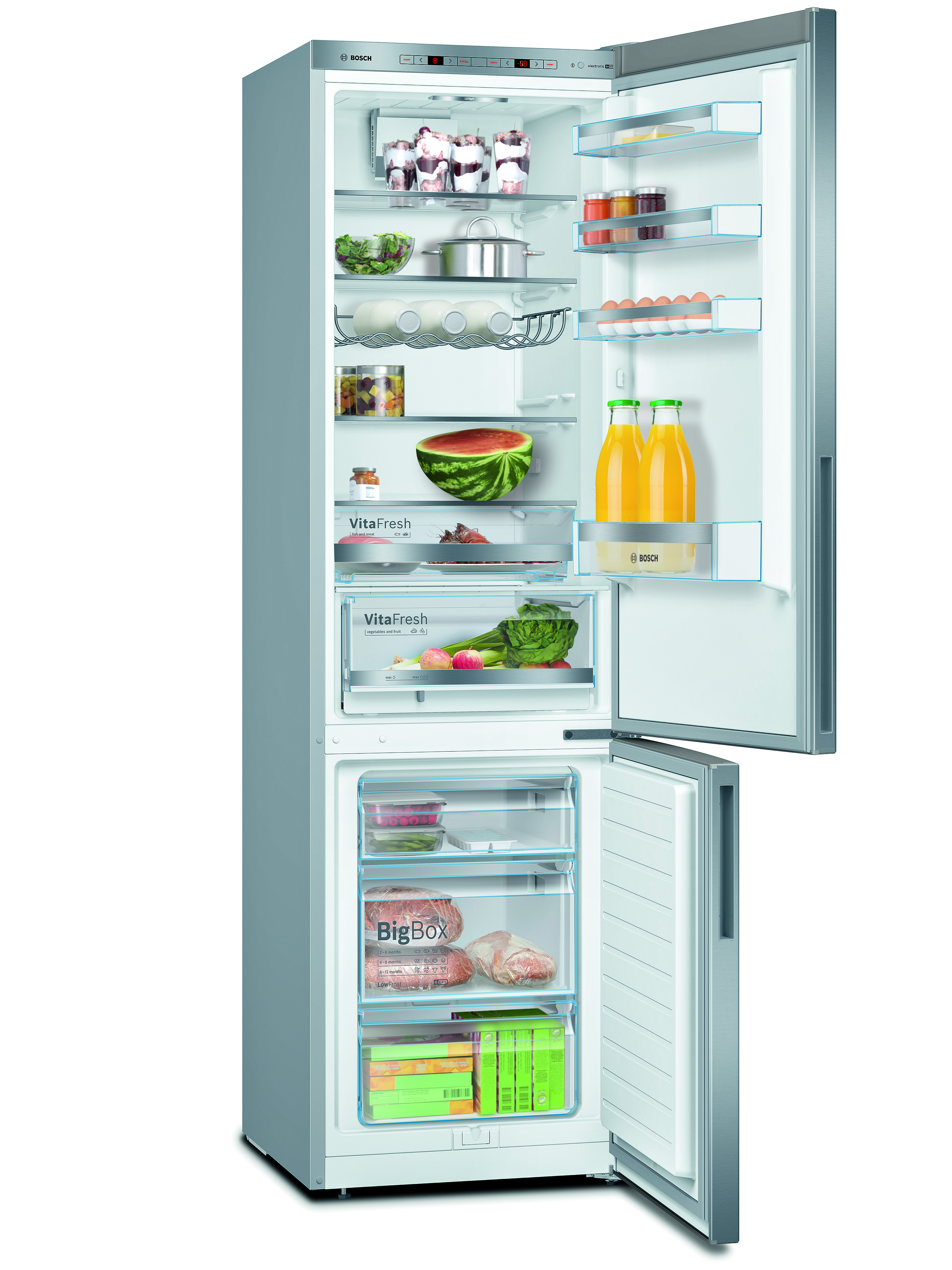 Opened stainless steel refrigerator filled with food. Watermelon, vegetables, eggs, and juice are visible.