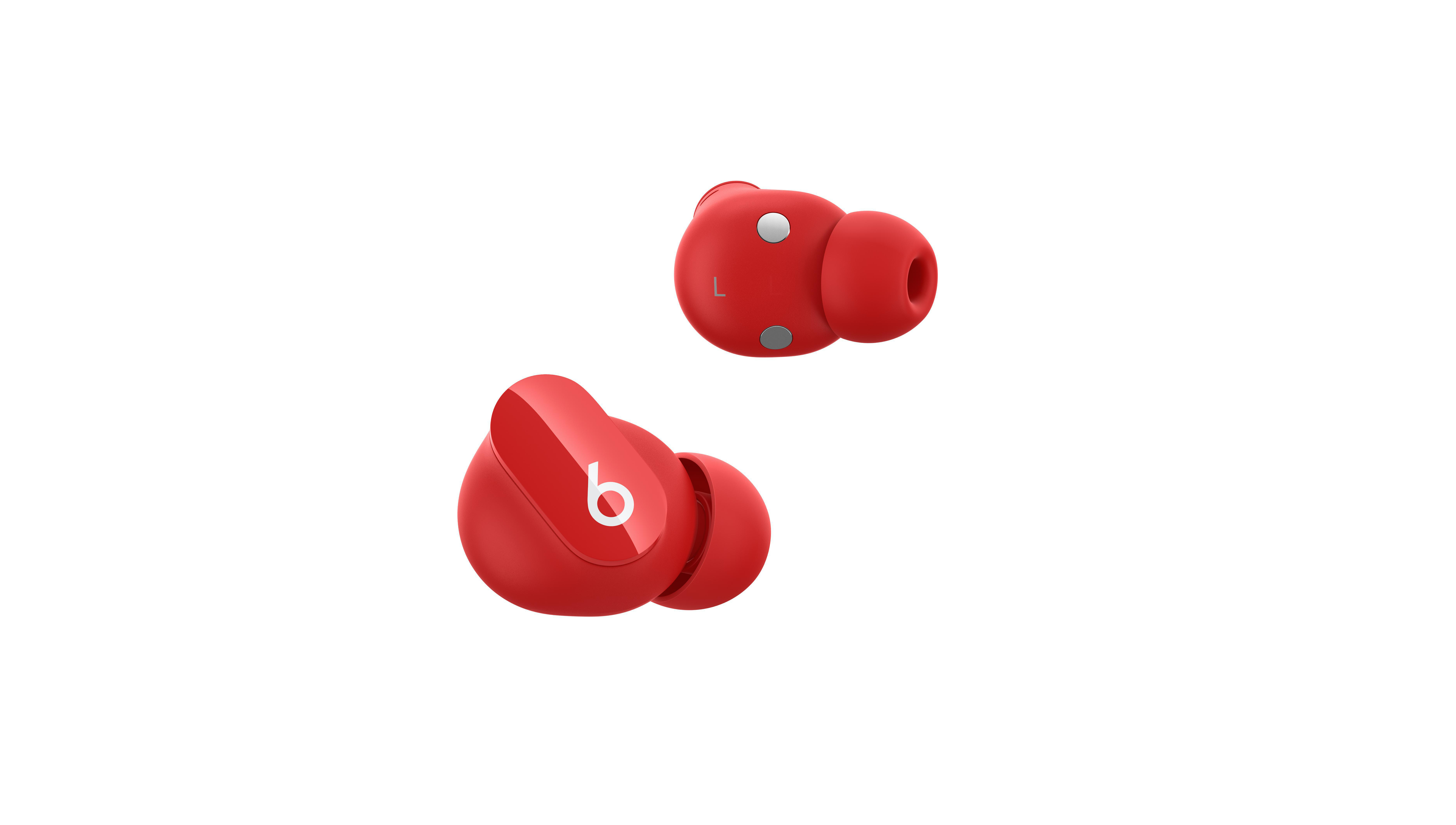 Zwei rote Ohrhörer mit weißem 'b'-Logo, auf weißer Oberfläche.