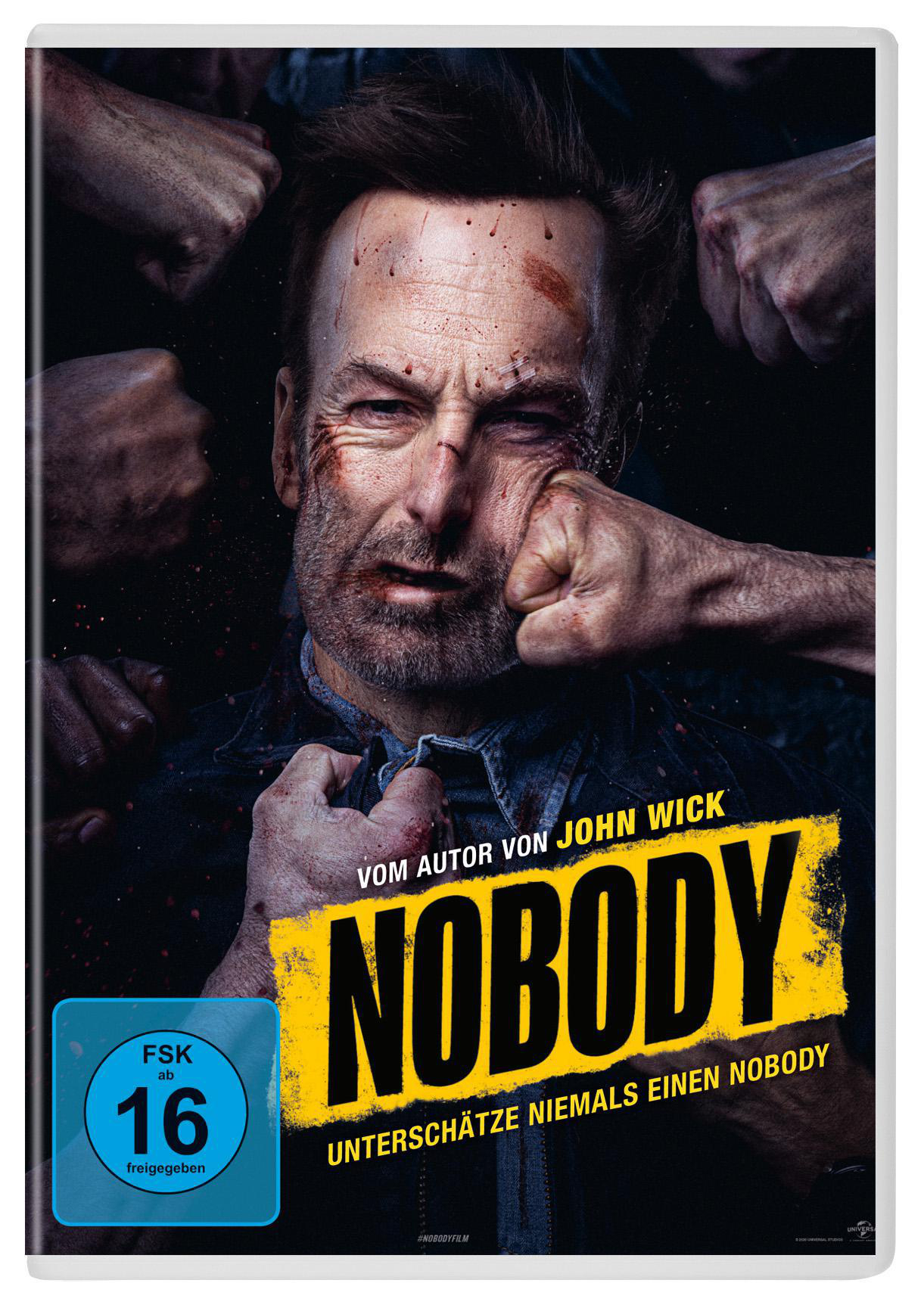 Filmcover mit Gesicht im Zentrum, Blutergüsse sichtbar. Titel 'Nobody', Fäuste umgeben Gesicht.