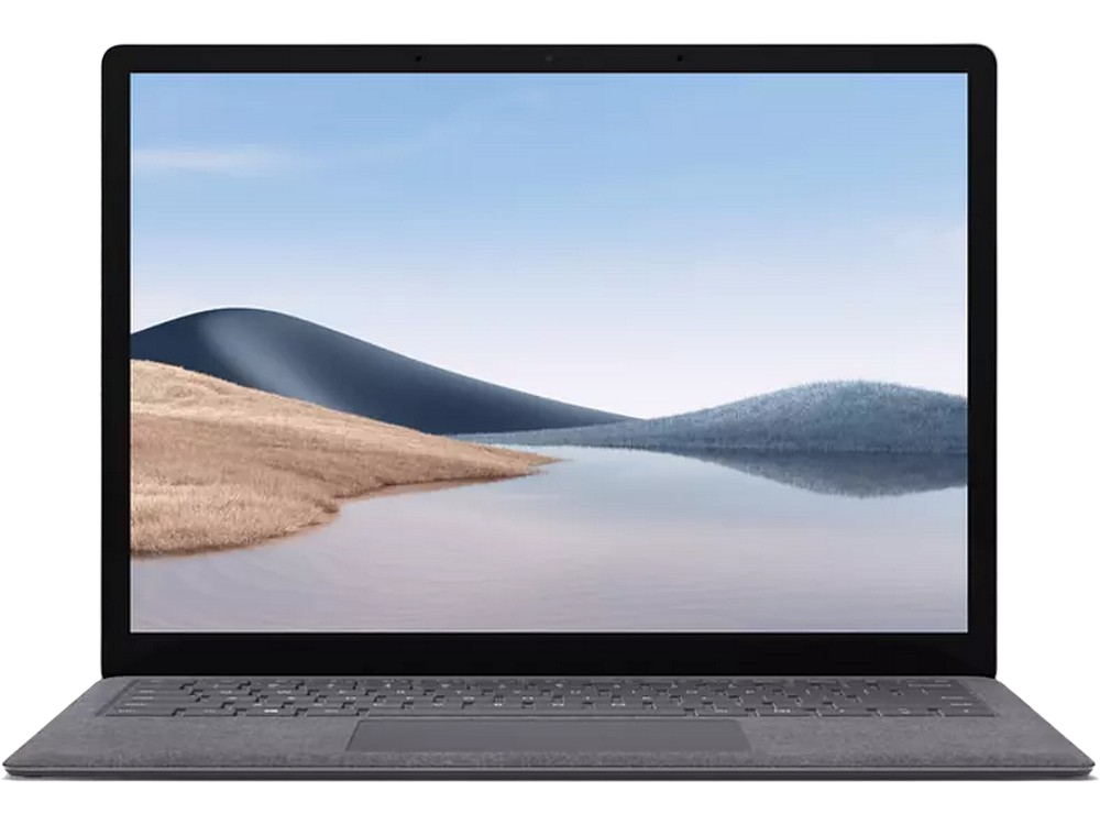 Un portátil gris con una pantalla que muestra un paisaje. El teclado es visible. Un fondo oscuro.