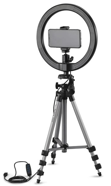 A ring light with a phone attached, on a tripod. Black and silver, white background.