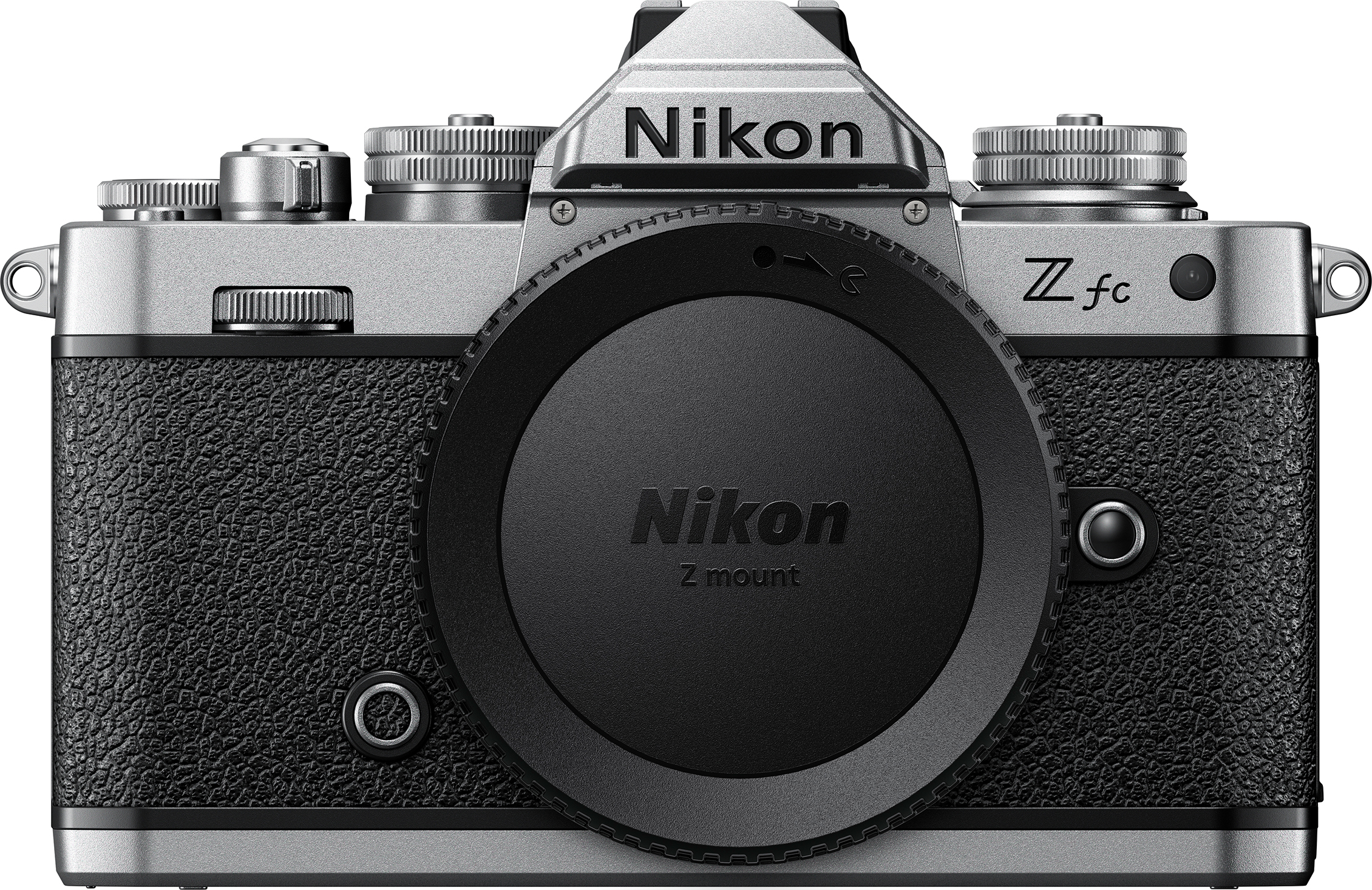 Appareil photo Nikon Z fc. Argent et noir, avec un cache objectif. Prise de vue produit en studio.
