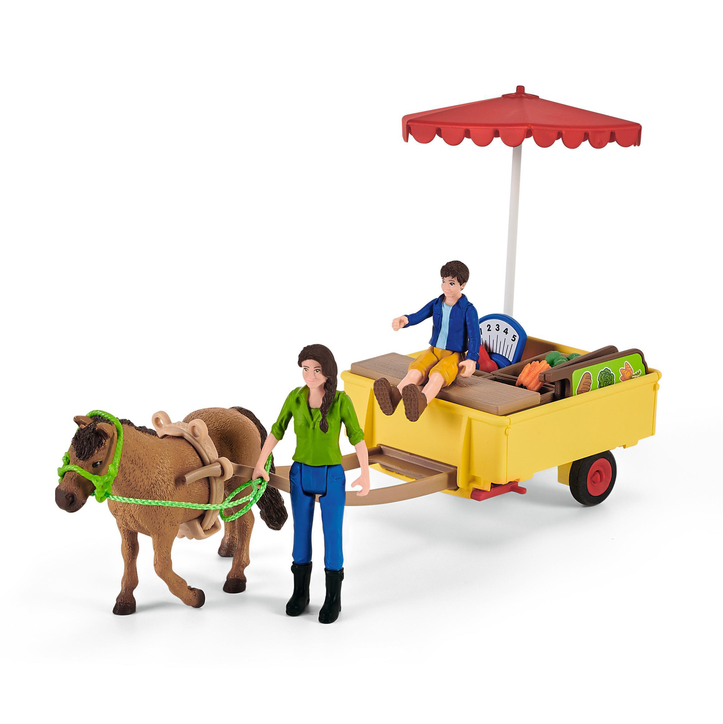 Ein Spielzeugmarkt mit einem pferdegezogenen Wagen, Figuren und einem roten Schirm. Ein Junge sitzt auf dem Wagen.