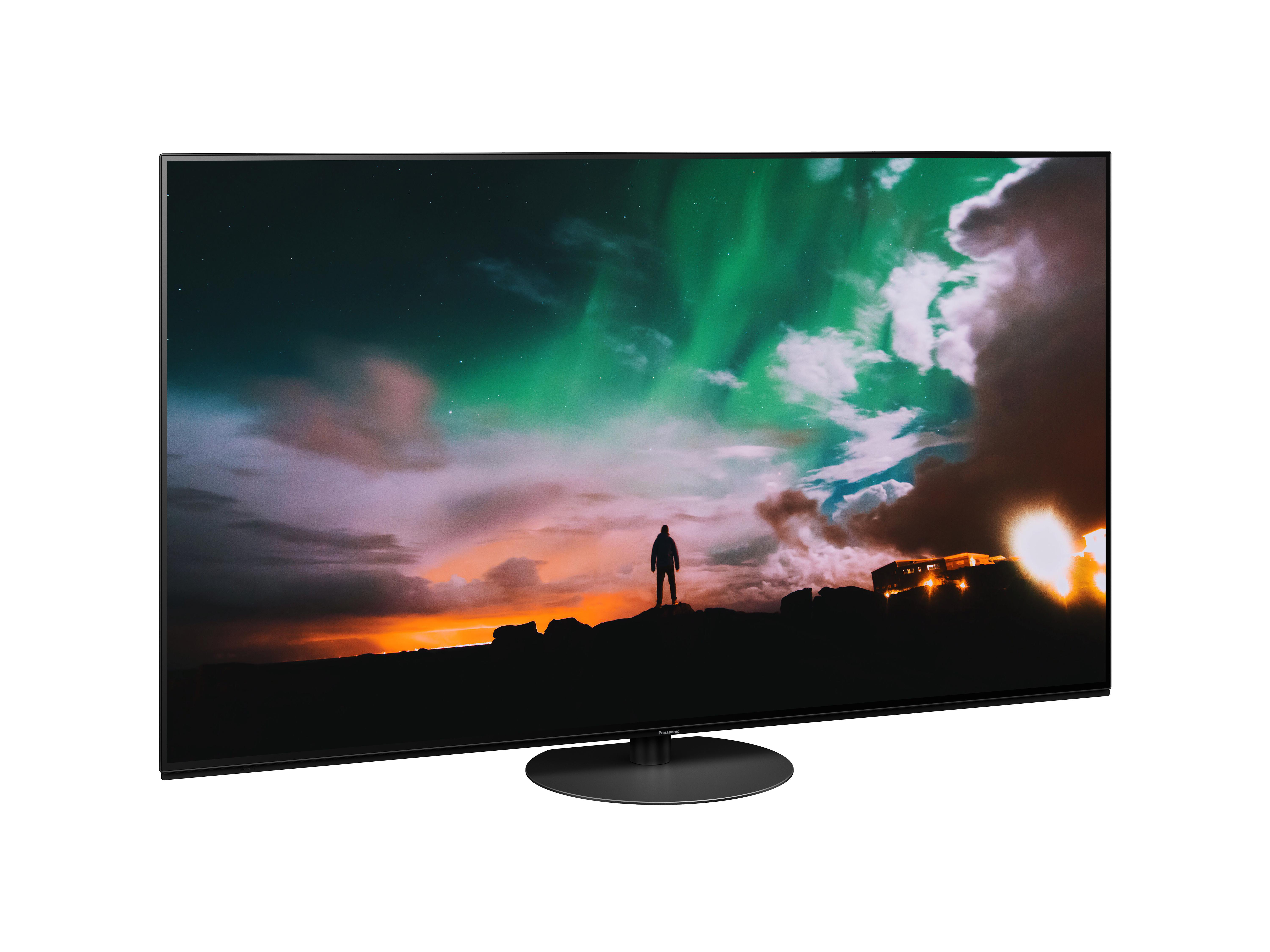 Großer Flachbildfernseher, der einen bunten Himmel mit einer Personensilhouette zeigt.
