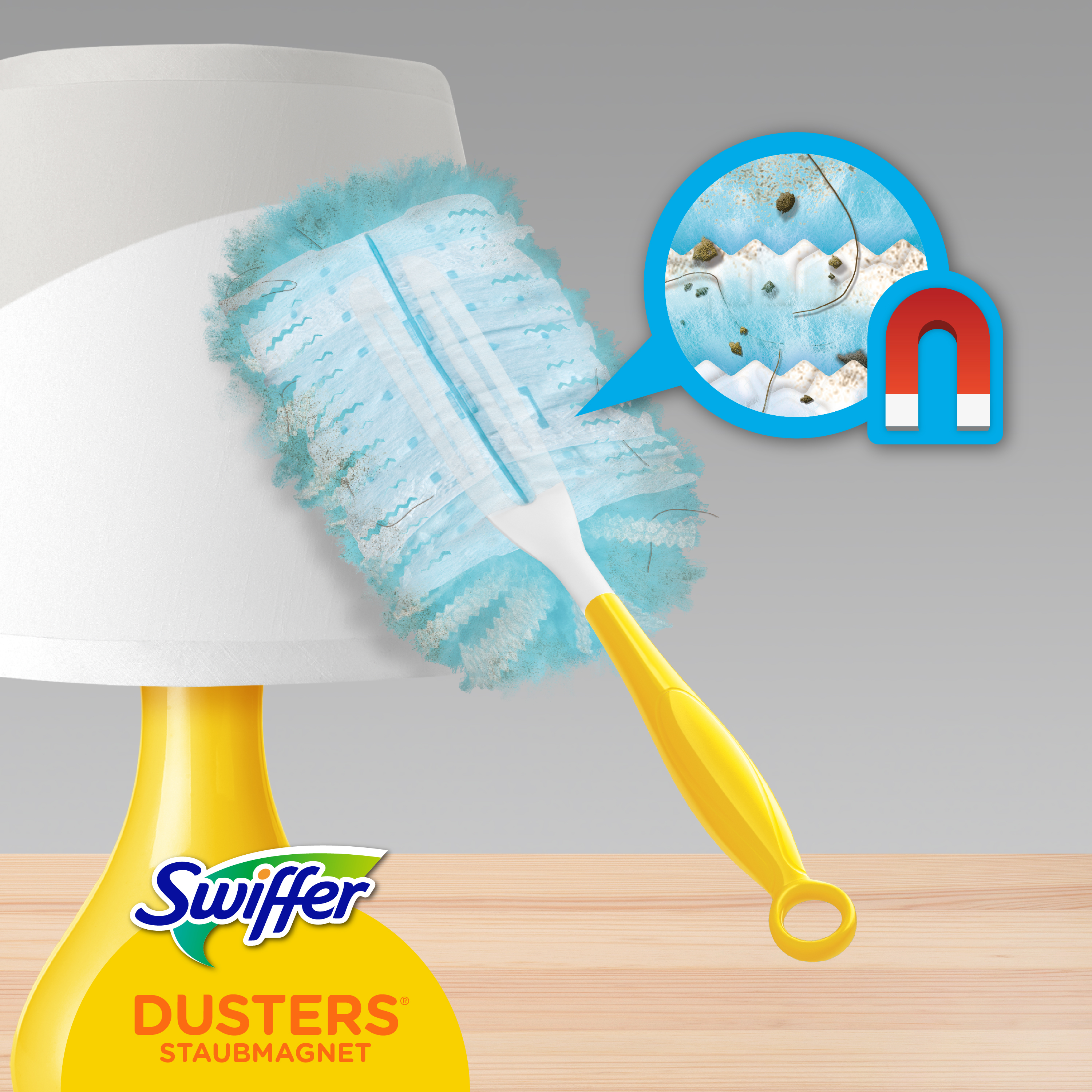 Swiffer-Staubwedel reinigt eine Lampe. Staub und Magnet in blauem Kreis dargestellt.