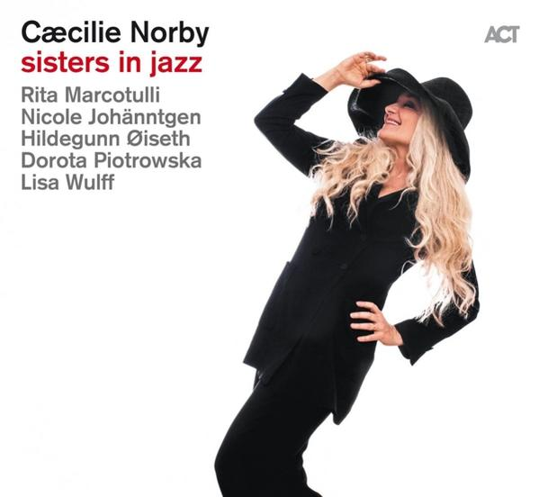 Albumcover mit einer blonden Frau in schwarzem Anzug und Hut, die posiert. Text und Namen sind sichtbar.
