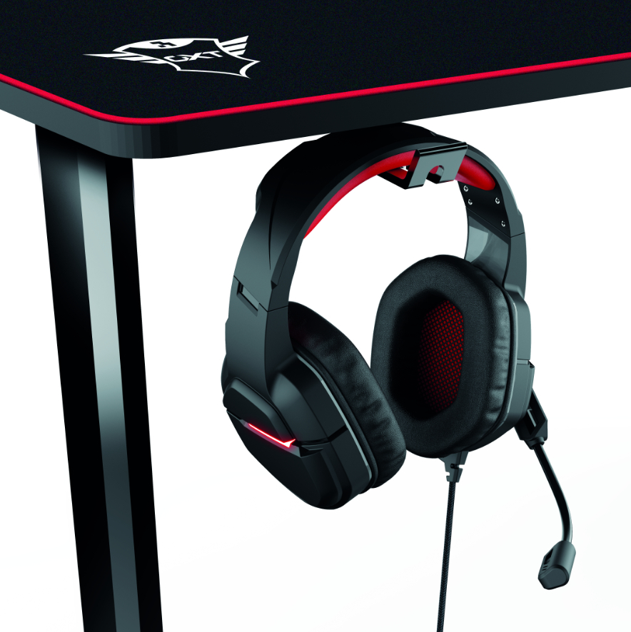 Schwarzes Gaming-Headset, das an einem schwarzen Schreibtisch mit rotem Rand hängt.
