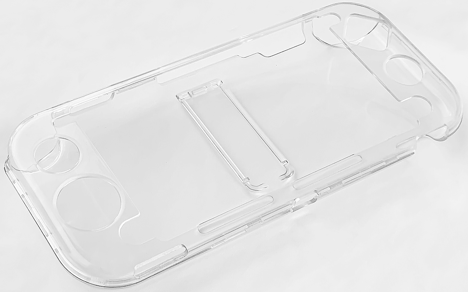 Clear, transparent plastic case for a handheld gaming device, lying on a white surface.