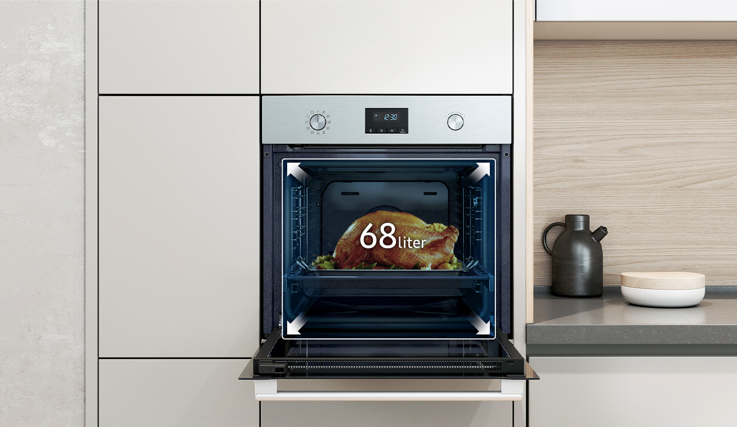 Oven, open, with a cooked chicken inside, and controls above.