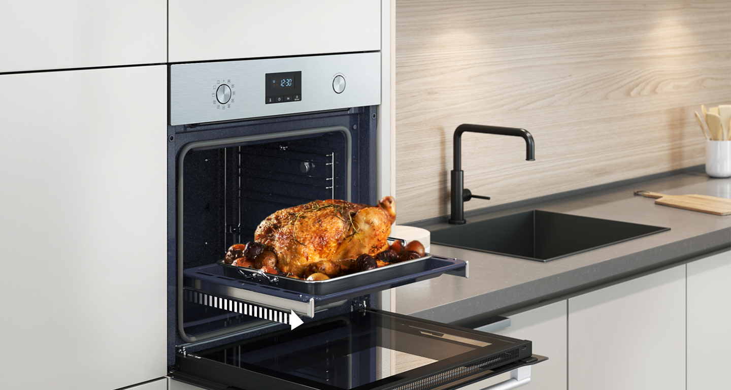 An oven with a roasted chicken on a tray. The oven door is open.