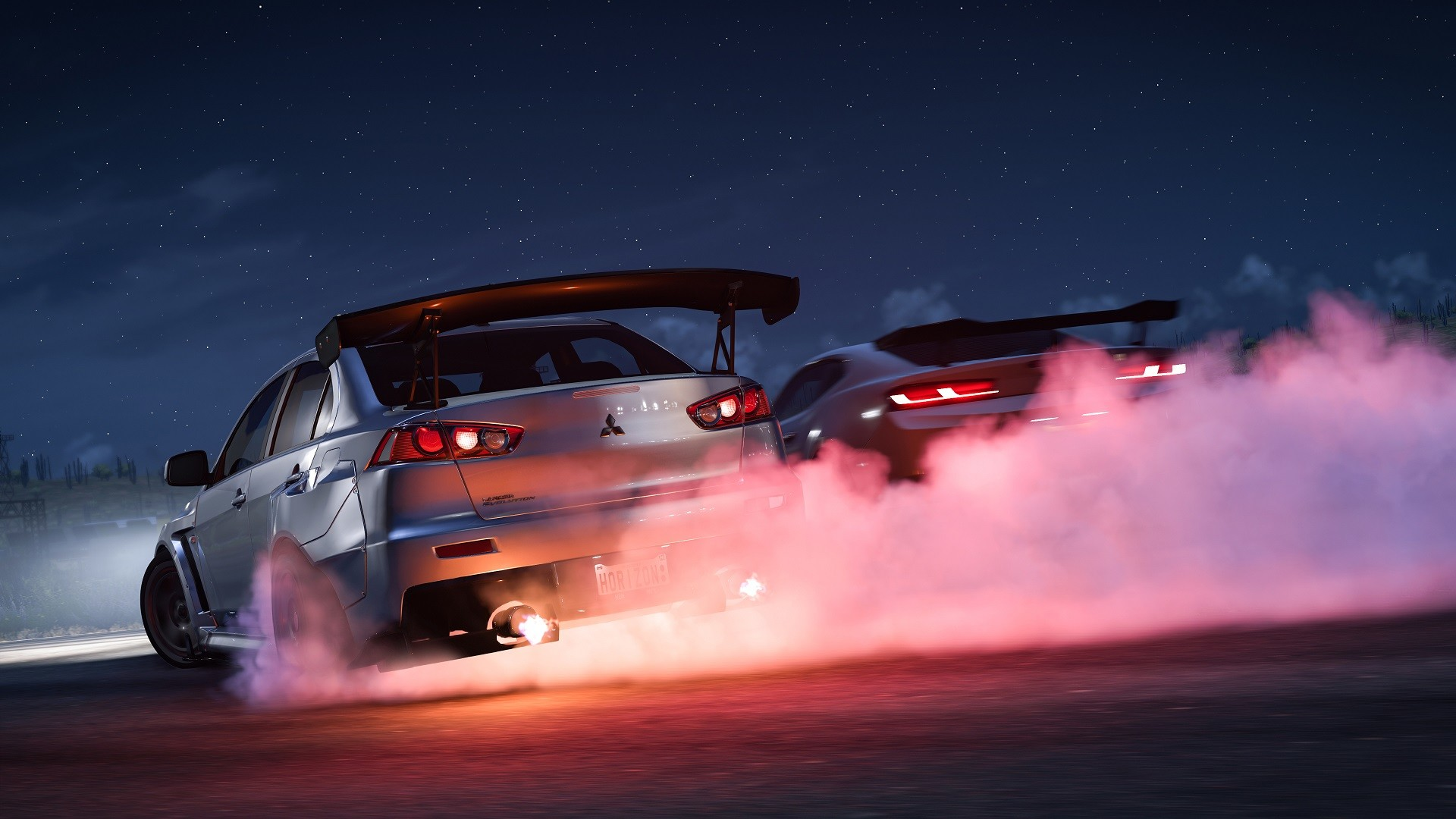 Zwei Rennwagen, einer driftet, mit Rauch. Nachtszene mit Sternenhimmel.