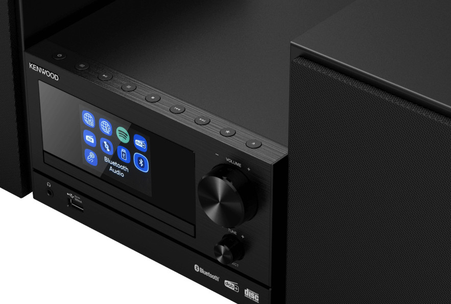 Close-up of a black Kenwood stereo system. Screen displays app icons.