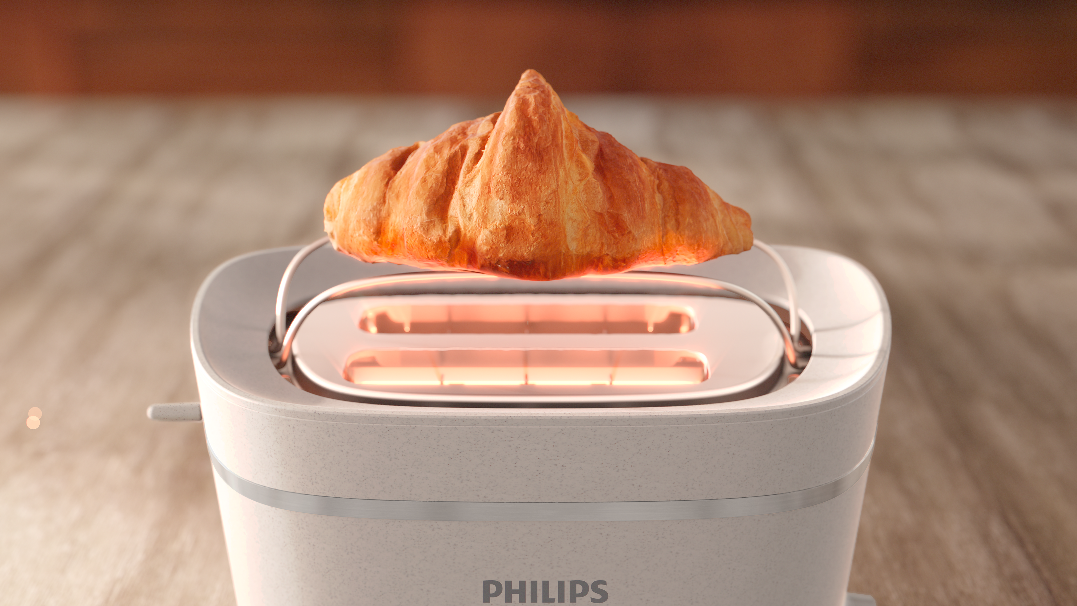 Ein weißer Toaster mit einem Croissant darin. Der Toaster steht auf einer Holzoberfläche.