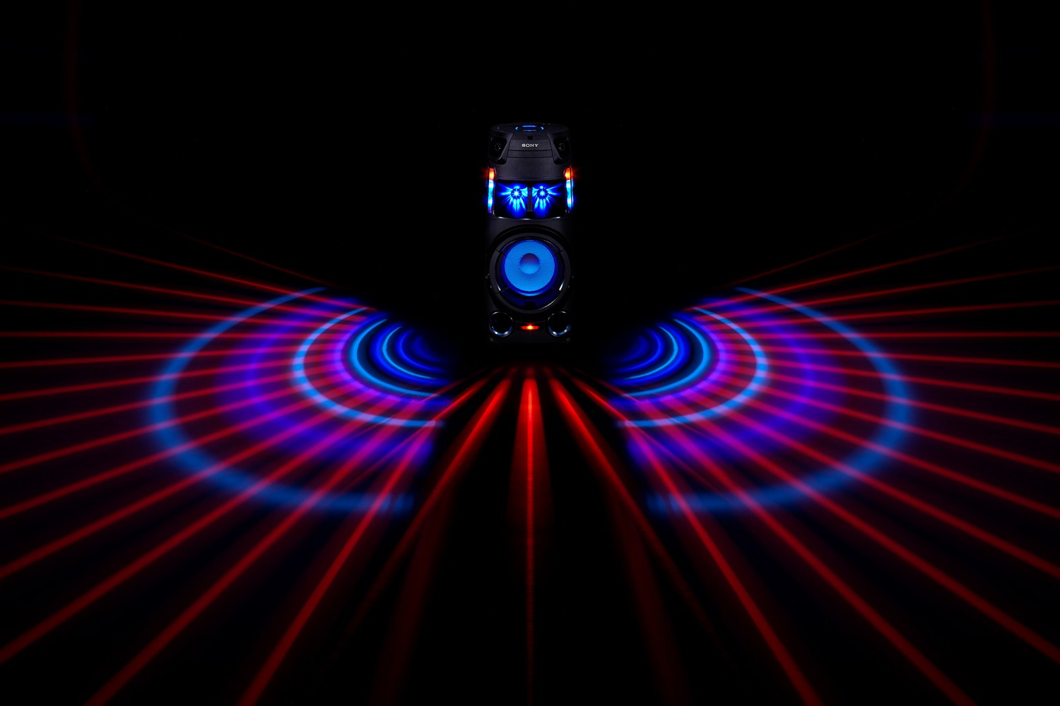 Altavoz negro con luces azules y rojas sobre fondo oscuro. Se muestran patrones de luz.