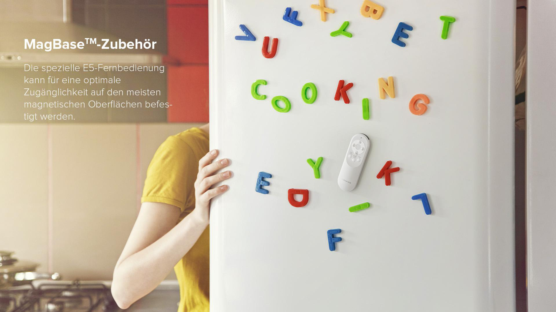 Kühlschrank mit magnetischen Buchstaben, die COOKING buchstabieren, und einer weißen Fernbedienung.