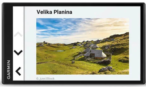 L'écran affiche un paysage intitulé Velika Planina. Il présente des collines vertes, un lac et une cabane sous le ciel bleu.