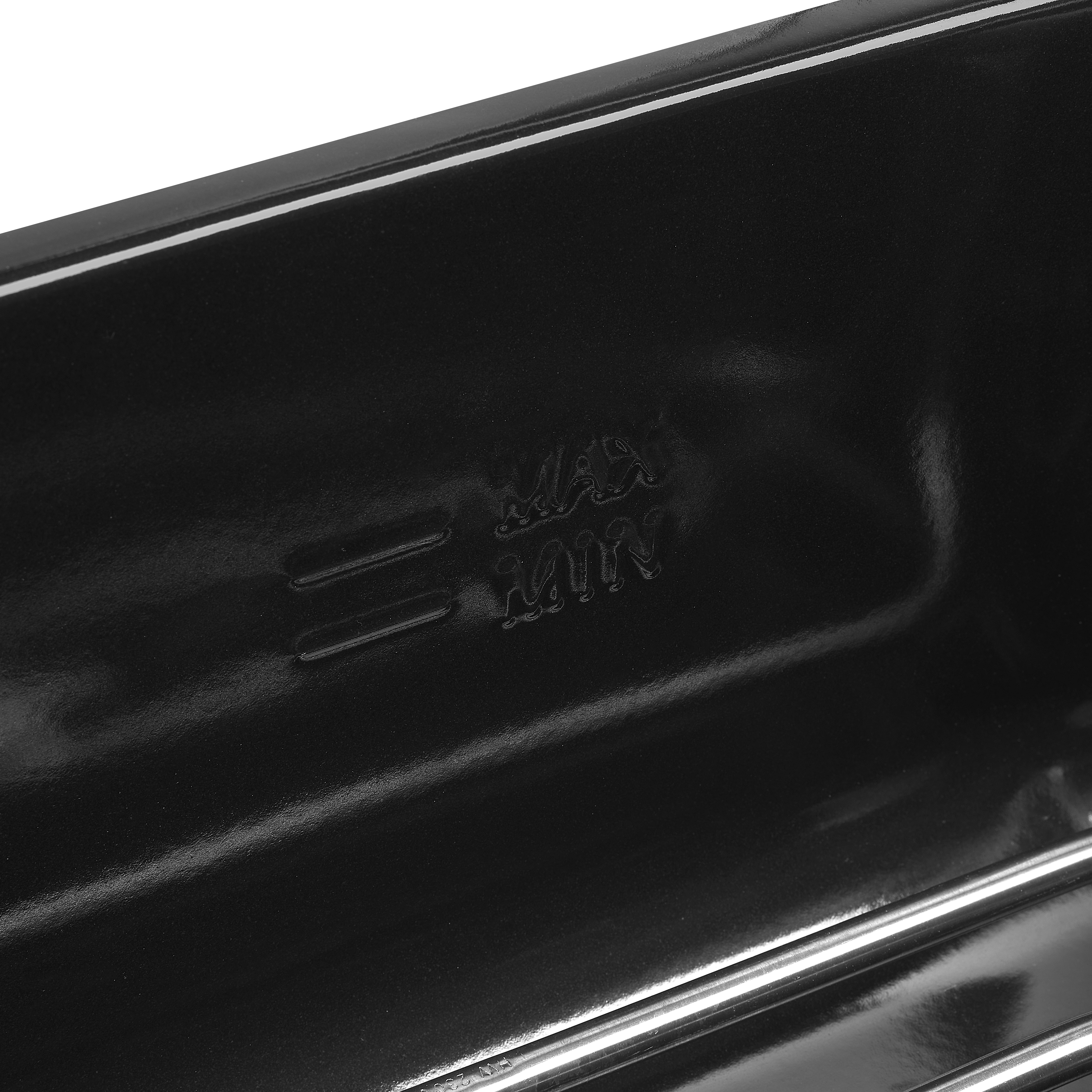 Close-up of a black baking tray with 'MAX' and 'MIN' markings visible.