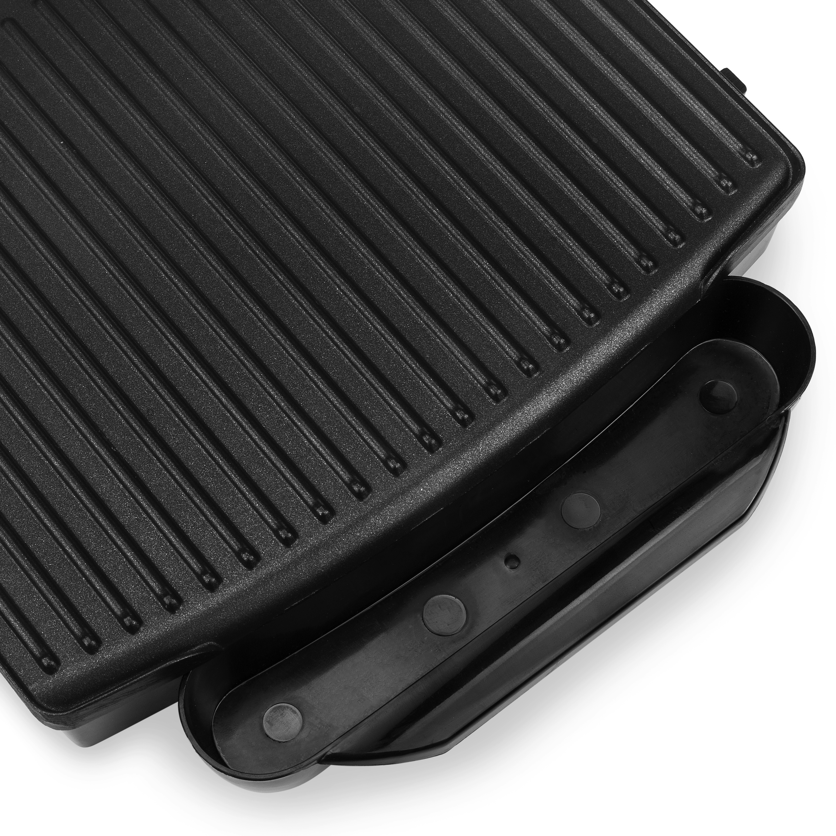 Close-up of a black grill with ridges, a handle, and a white background.