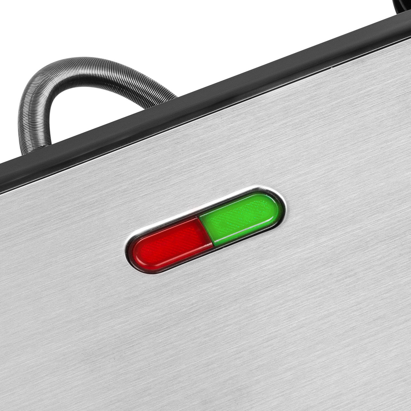 Close-up of a stainless steel appliance with red and green indicator lights.
