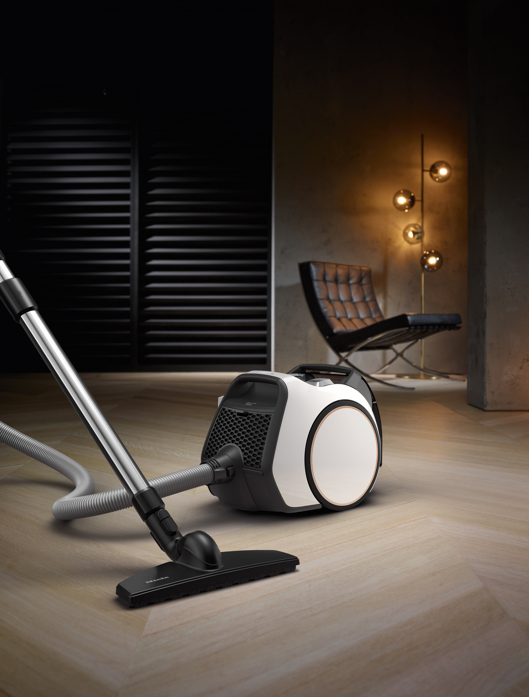Modern vacuum cleaner, black and white, on wooden floor, in a modern room.