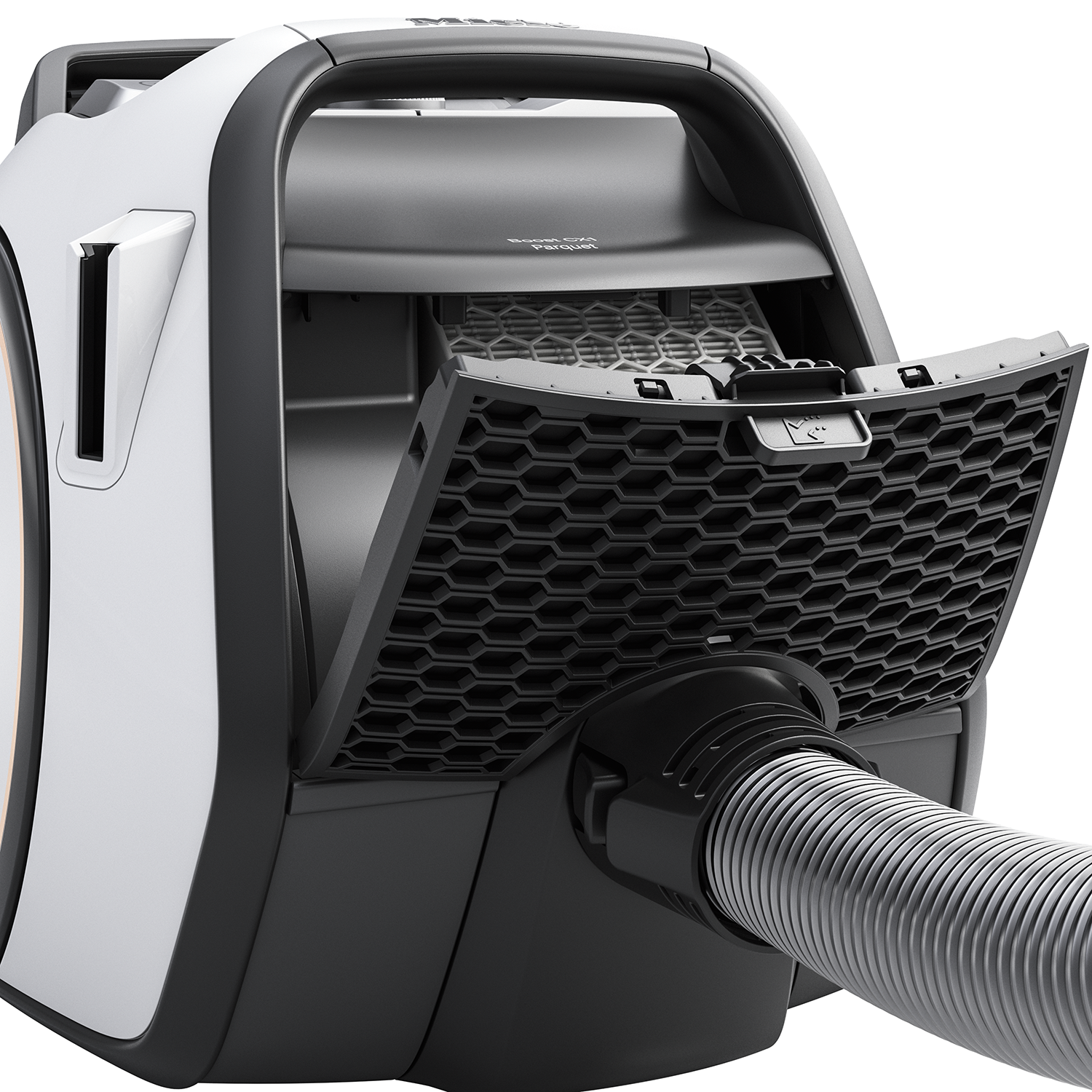 Vacuum cleaner with open compartment and hose.
