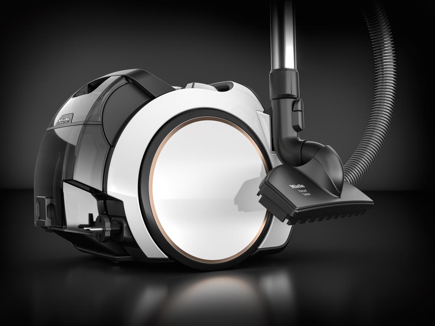 A vacuum cleaner with a black and white design, and a curved nozzle attachment.