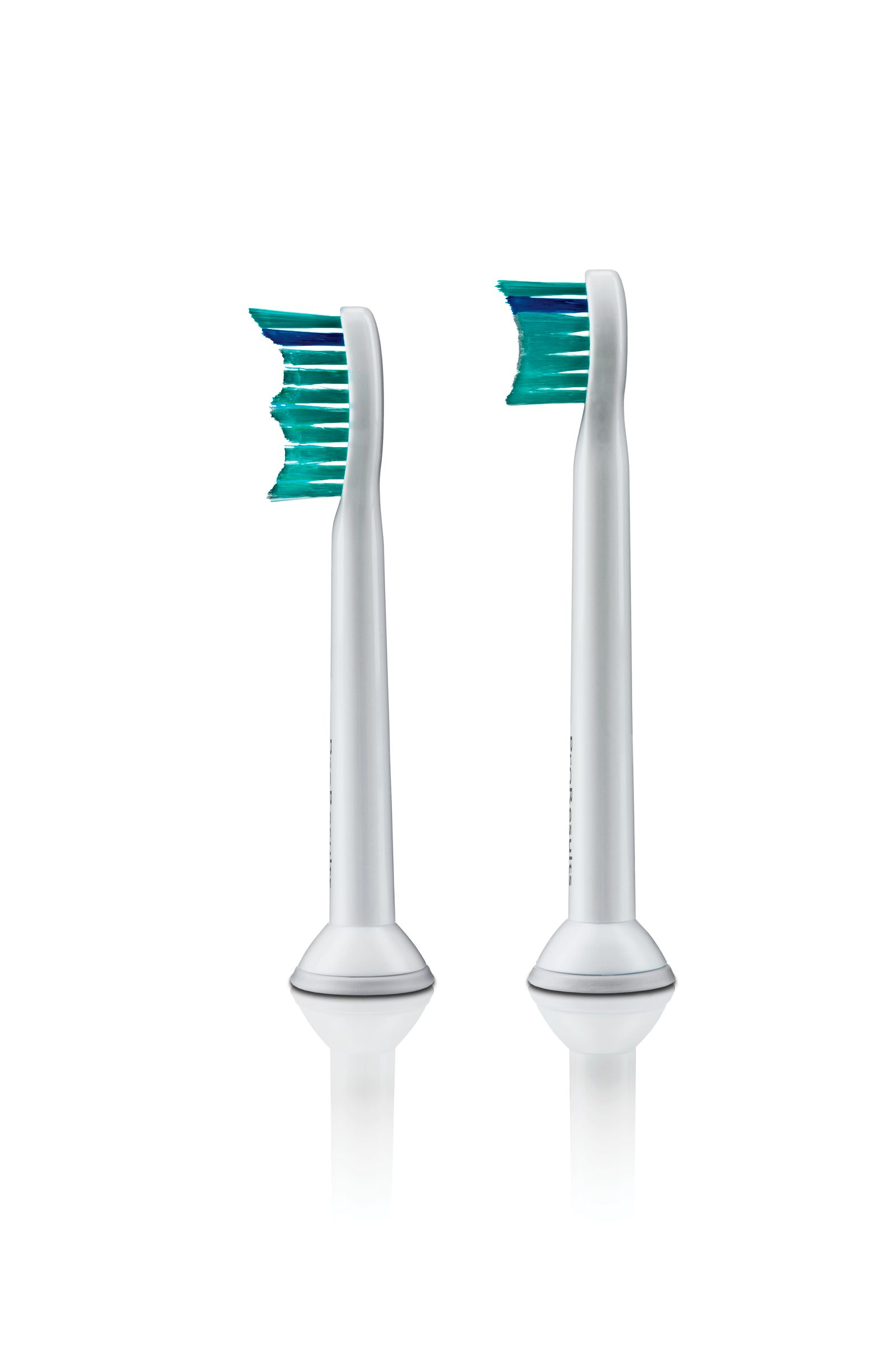 Two white toothbrush heads with blue and green bristles on a white background.