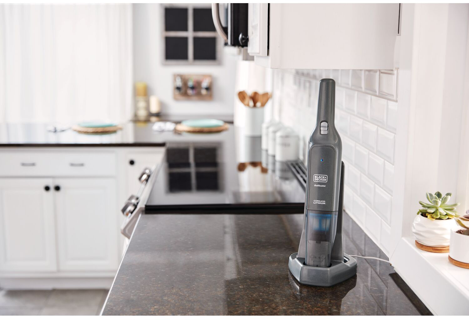 Black and Decker cordless vacuum on a kitchen countertop. Black and gray.