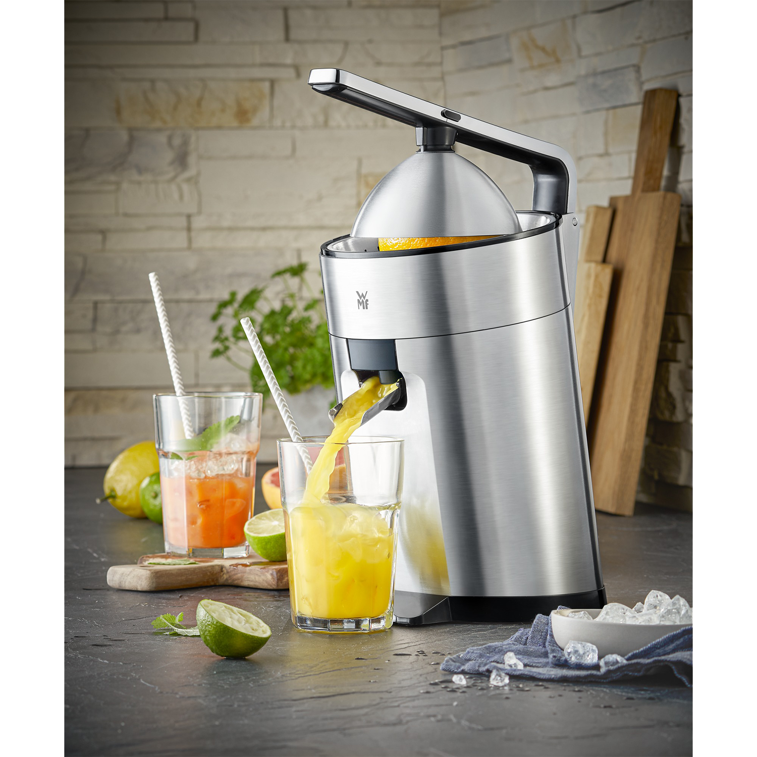 Juice being poured into a glass with a juicer in the background.