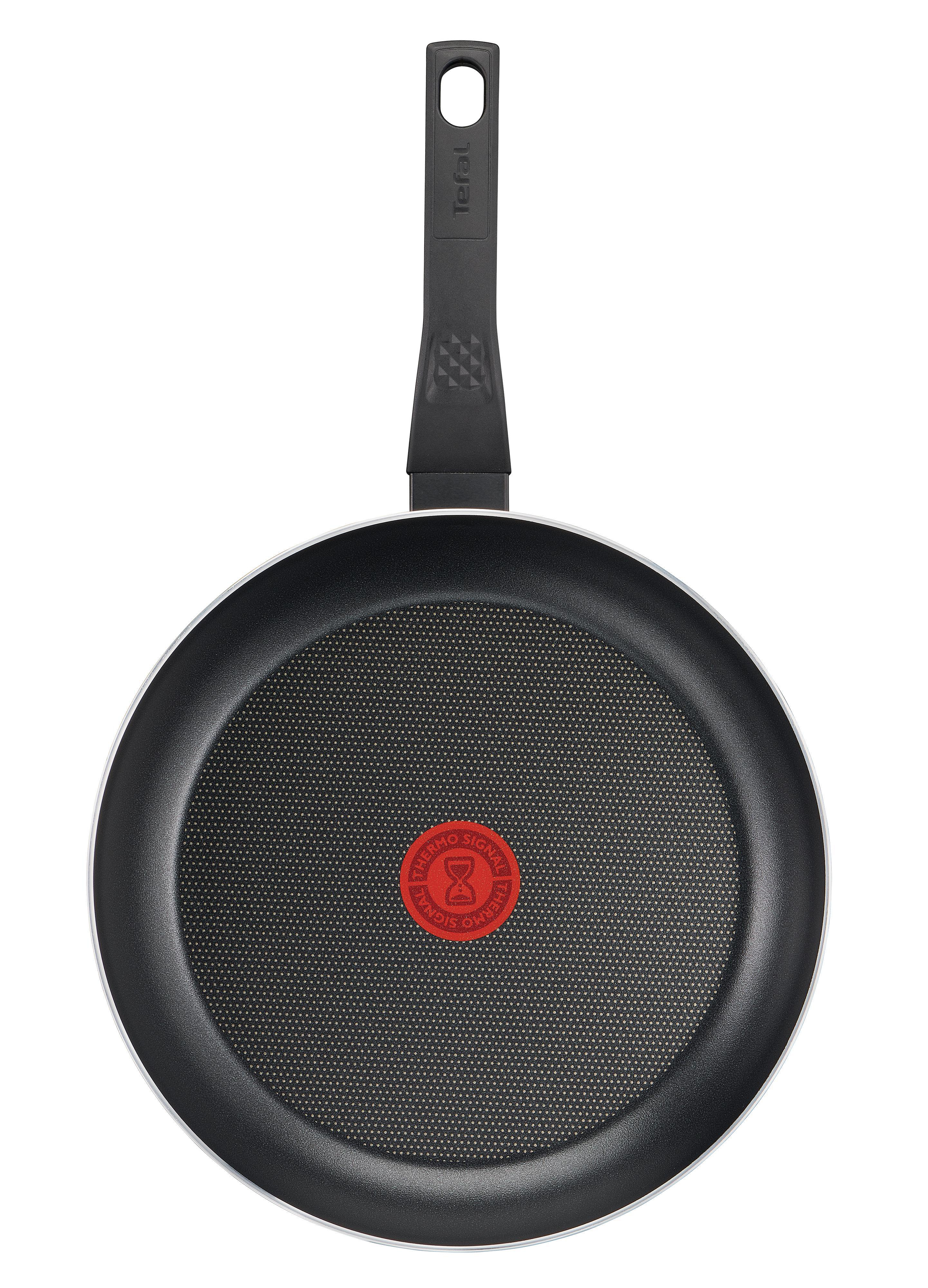 Eine schwarze Tefal-Bratpfanne mit rotem Punkt in der Mitte, von oben gesehen.