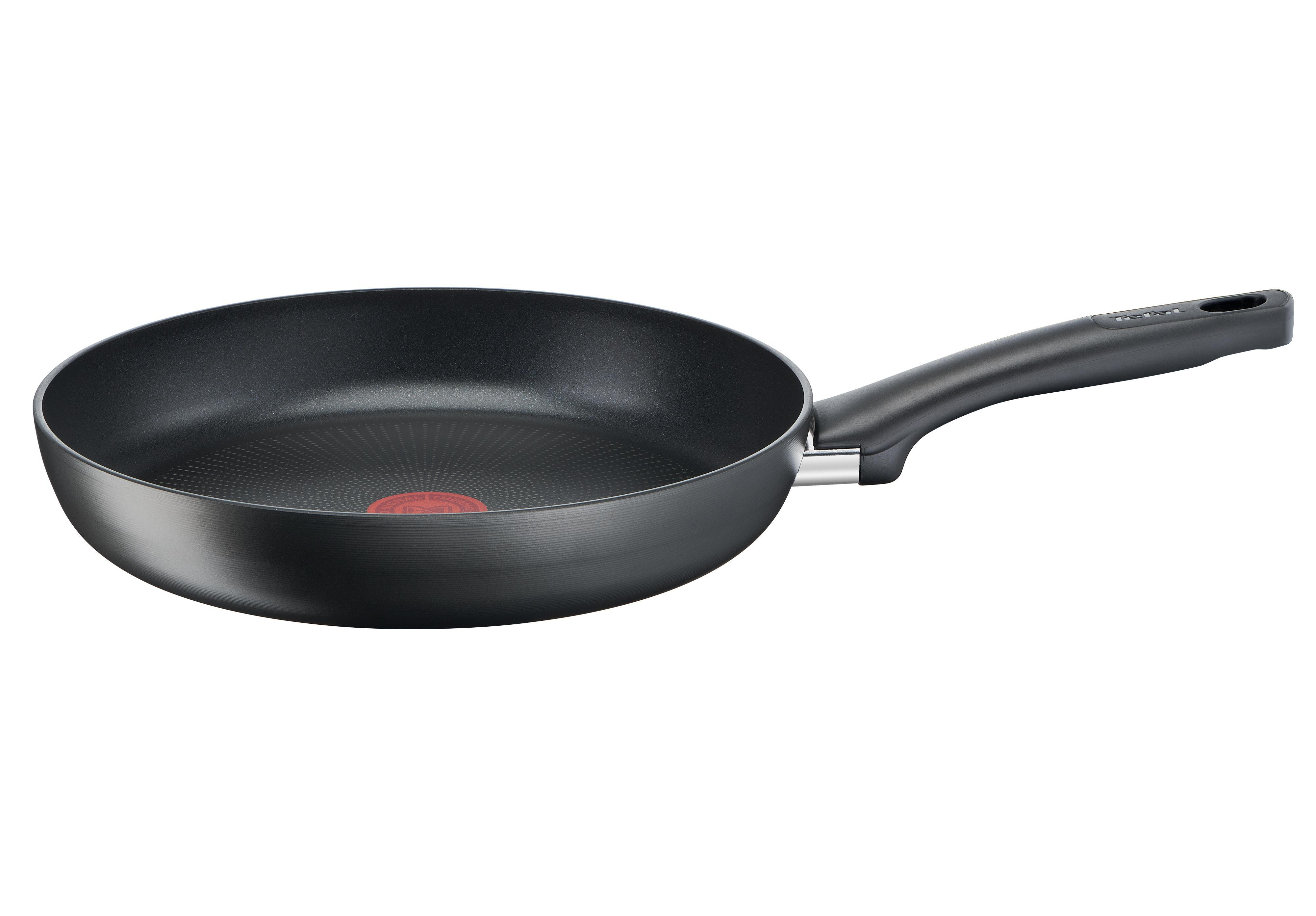 Schwarze Bratpfanne mit schwarzem Griff auf weißem Hintergrund. Ein rotes Logo befindet sich in der Mitte.