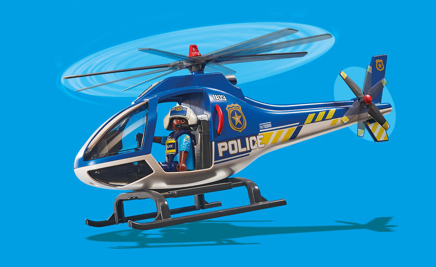 Blauer Spielzeug-Polizeihubschrauber mit einer Figur im Cockpit.