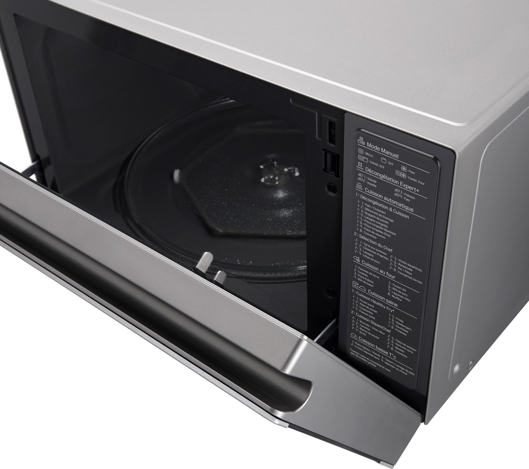 A silver microwave oven with the door open. Control panel on the right, glass turntable inside.