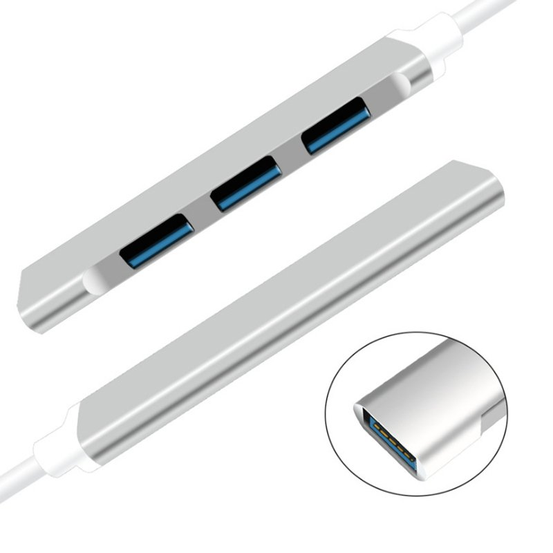 Gümüş USB hub, üç mavi USB portu ve beyaz kablo ile.