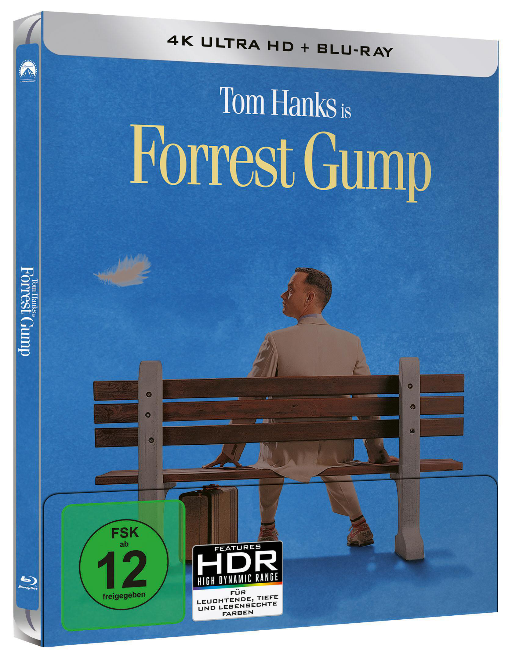 Forrest Gump Blu-ray-Cover. Tom Hanks auf einer Bank mit Feder und Koffer.