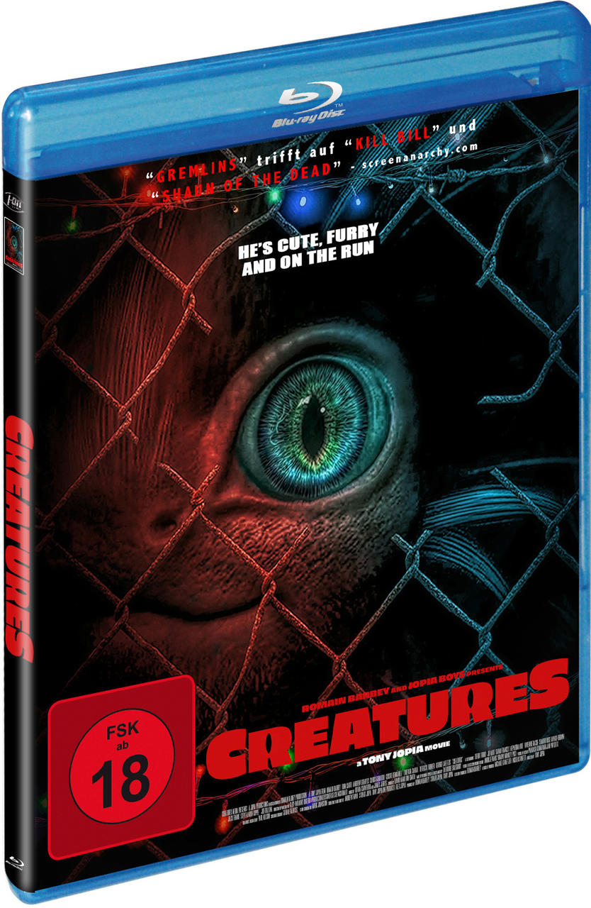 Blu-ray-Disc-Cover des Films 'Creatures' mit einer Nahaufnahme eines Auges hinter einem Zaun.