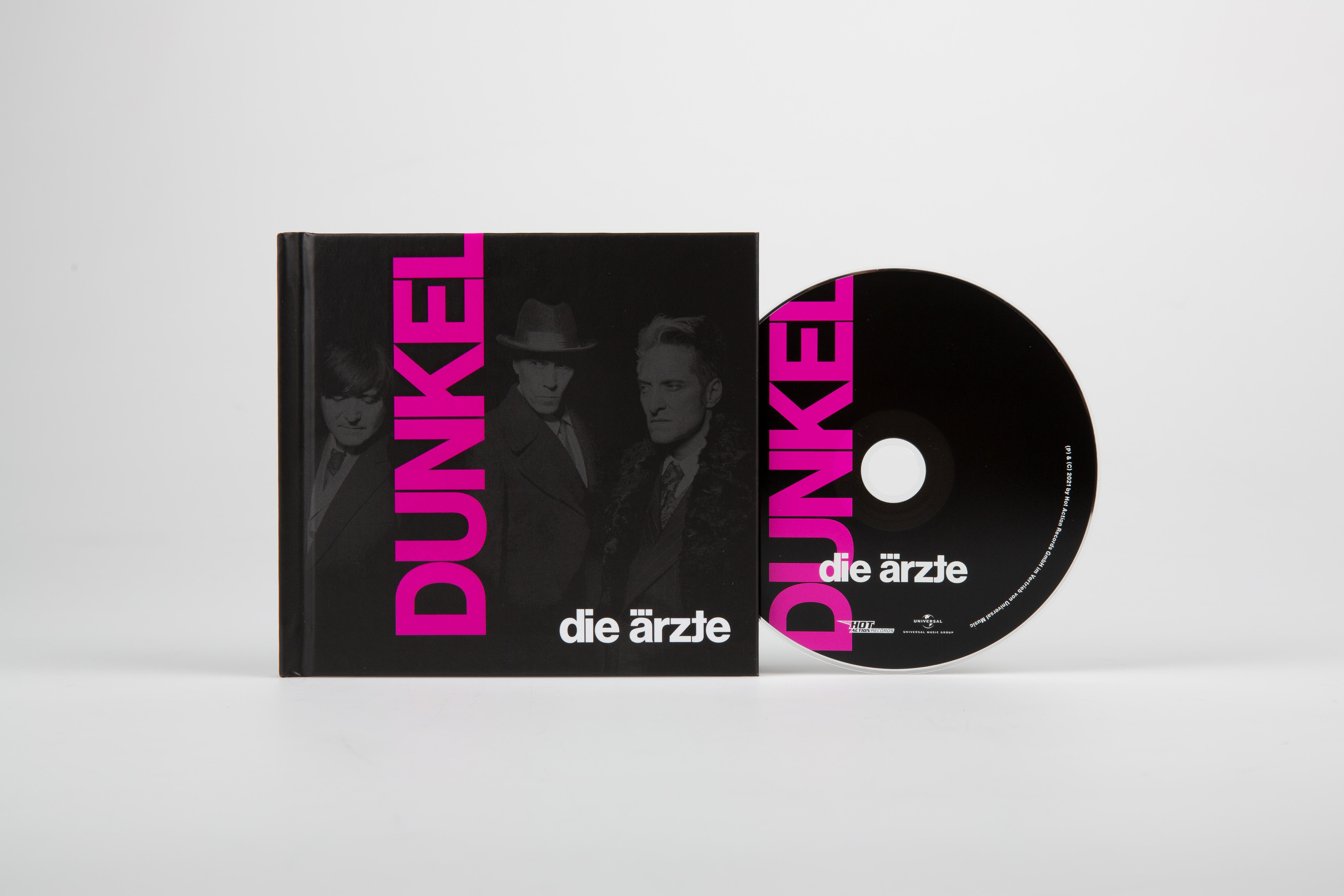 Albumcover und CD von 'DUNKEL' von Die Ärzte, schwarz mit pinkem Text.