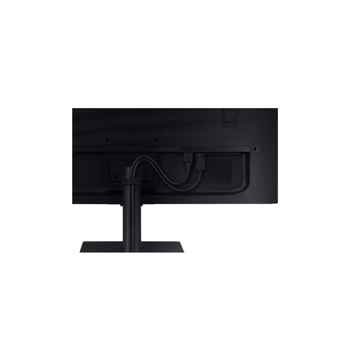 Parte trasera de un monitor de computadora negro con cables enchufados en la parte trasera, sobre un fondo negro.