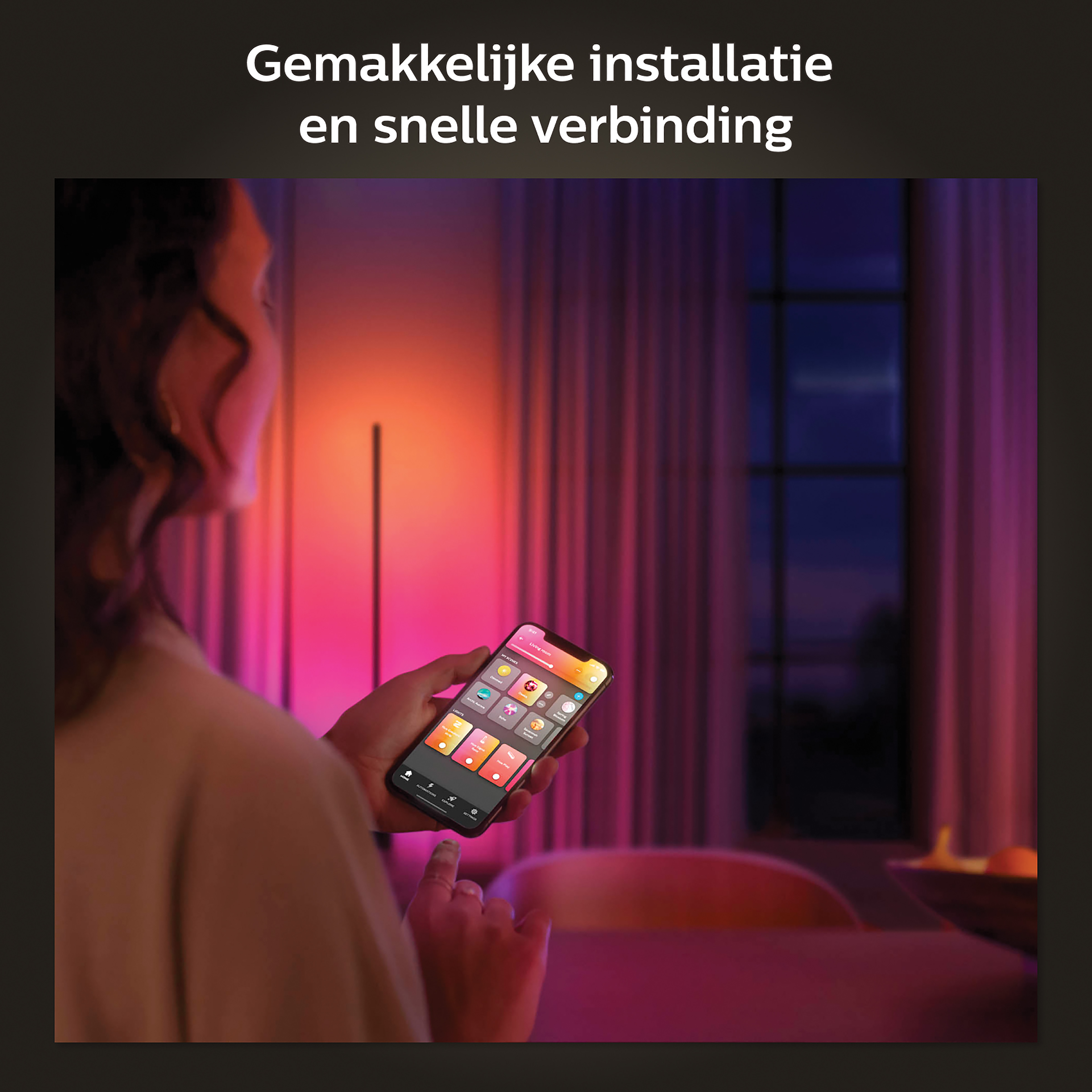 Woman using a phone, controlling smart lights in a room with pink and purple hues.