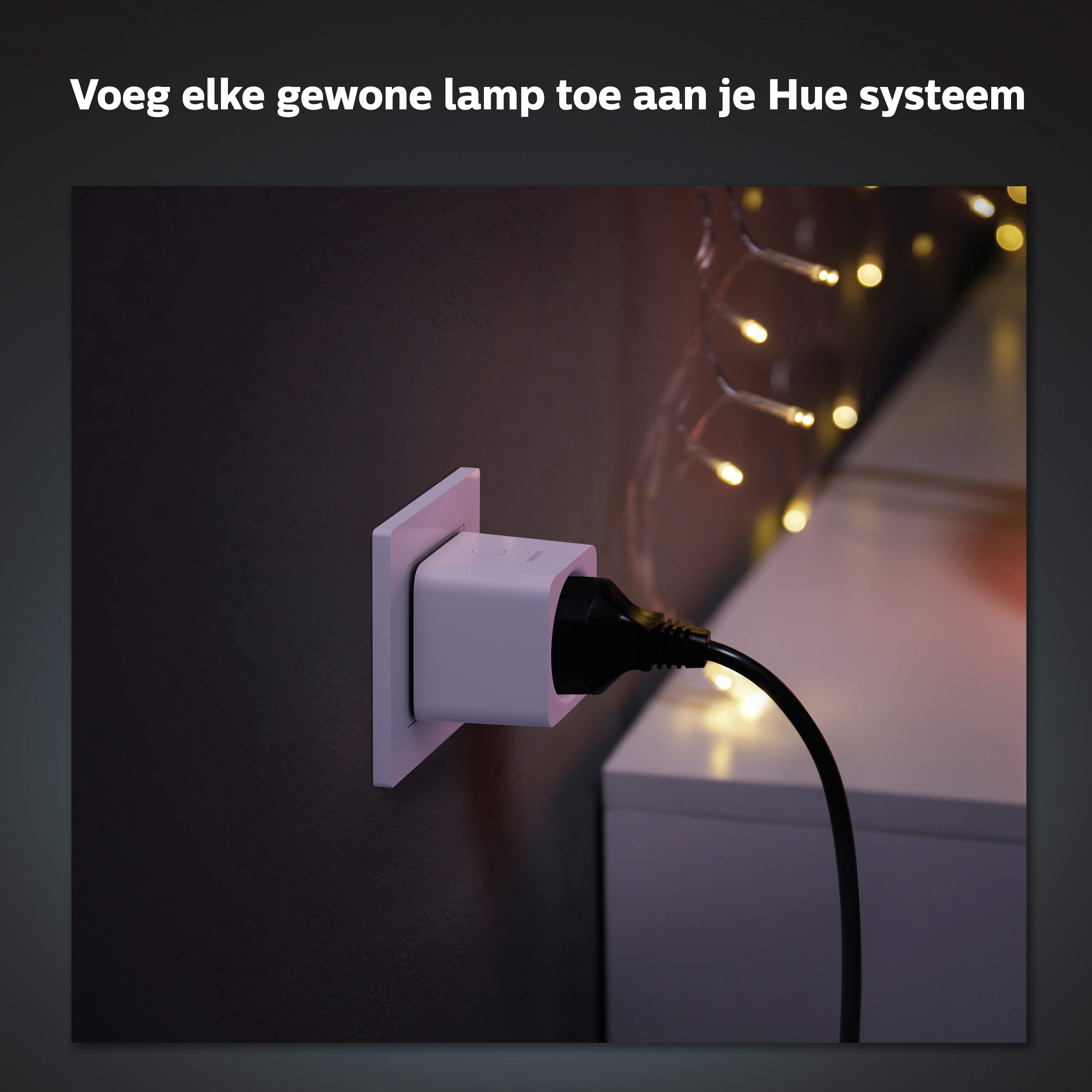 A white smart plug connected to a black wall socket. A string of lights is in the background.